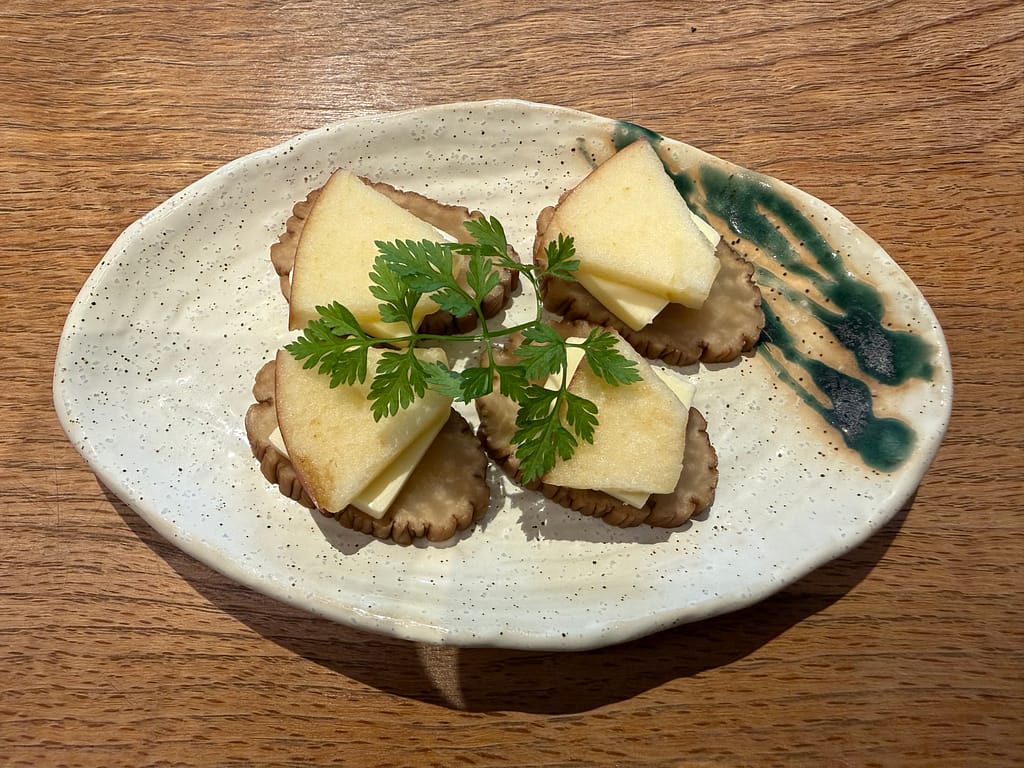 かるまる池袋の『いぶりがっこチーズ』。燻製たくあんとクリームチーズを組み合わせた人気のおつまみ。