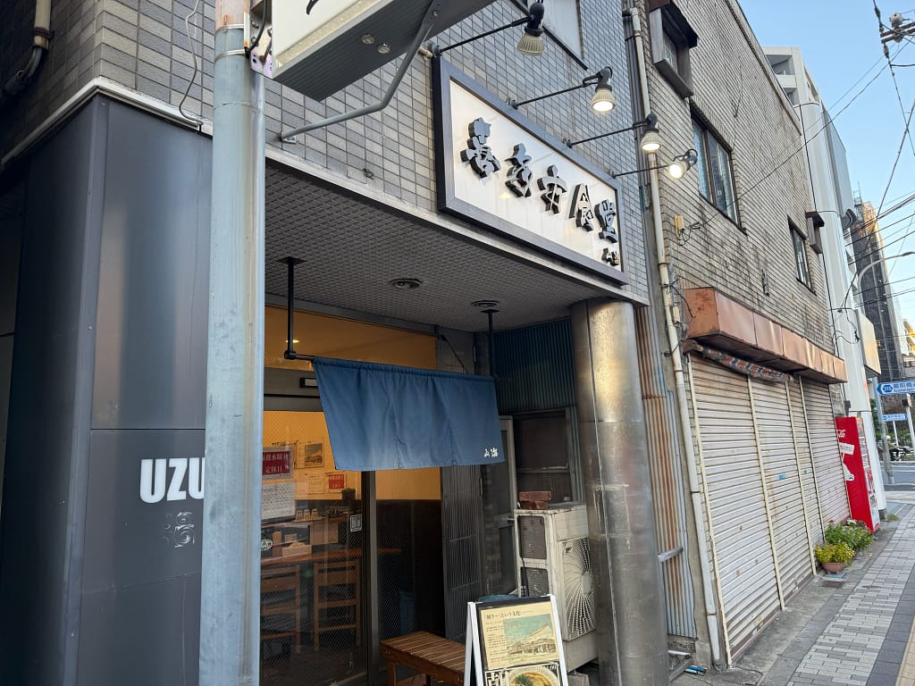 錦糸町にある「喜多方食堂 山海」の外観と暖簾、入口周辺の街並みの様子
