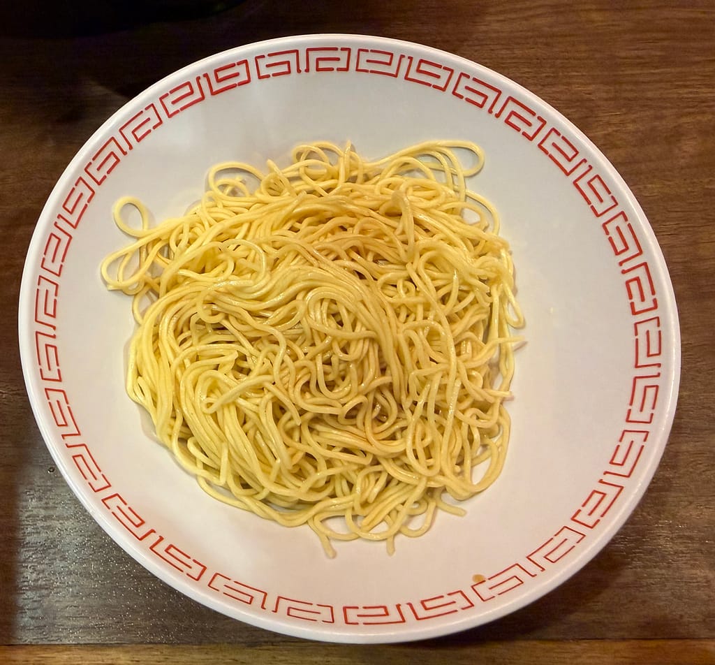 一蘭の替え玉用の細麺。白い丼に盛られたストレート麺。